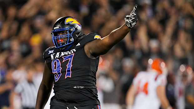 Sep 8, 2023; Lawrence, Kansas, USA; Kansas Jayhawks defensive lineman Kenean Caldwell (97) celebrates after an interception against the Illinois Fighting Illini during the second half at David Booth Kansas Memorial Stadium. Mandatory Credit: Jay Biggerstaff-USA TODAY Sports  